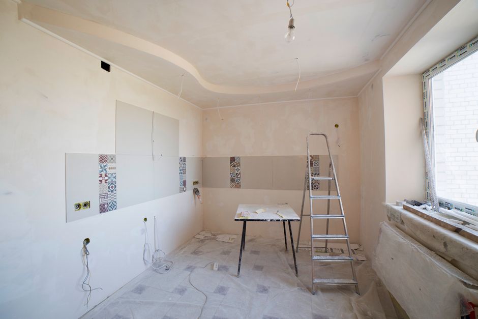 Tradesman fitting a new bathroom suite during a full bathroom renovation in a Liverpool semi-detached house
