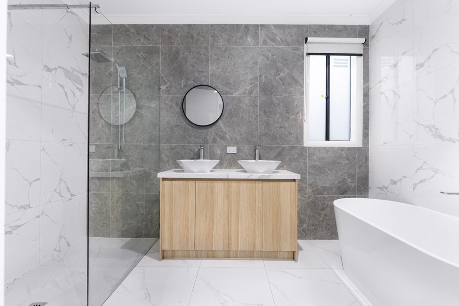 Complete bathroom renovation Liverpool showing walk-in shower with tiled walls and ceiling-mounted extractor fan