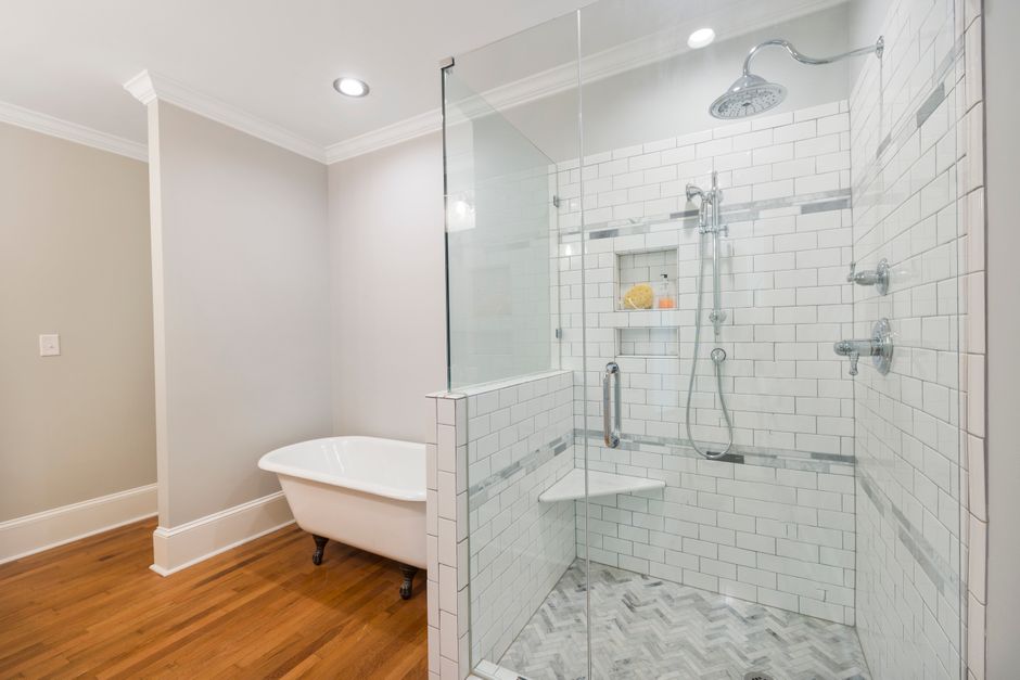 Completed ensuite bathroom renovation in a Liverpool city-centre flat, showing a tiled walk-in shower and contemporary vanity unit