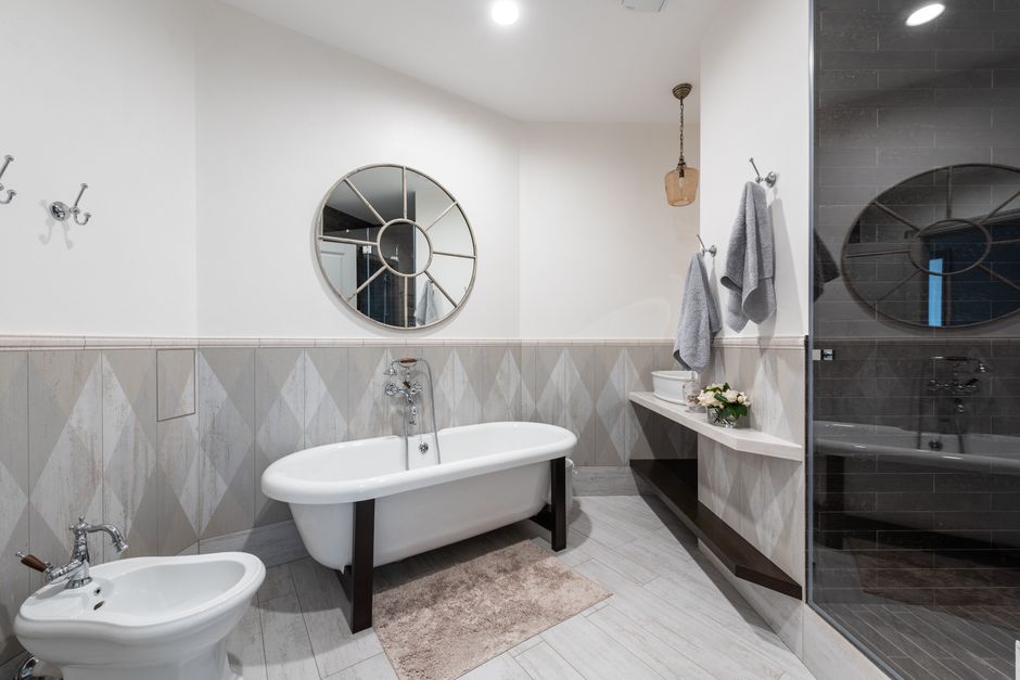 Modern UK bathroom showing both a freestanding bath and a walk-in shower, illustrating the bath or shower which adds more value question