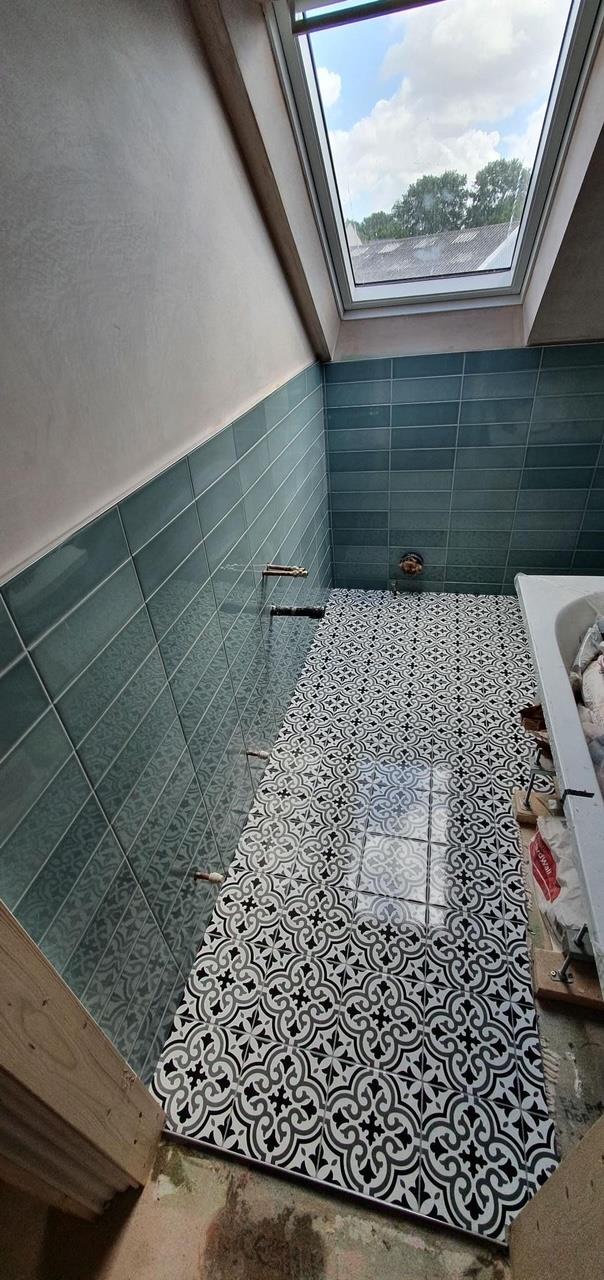 Loft bathroom renovation with patterned floor by Kew Construction, Liverpool