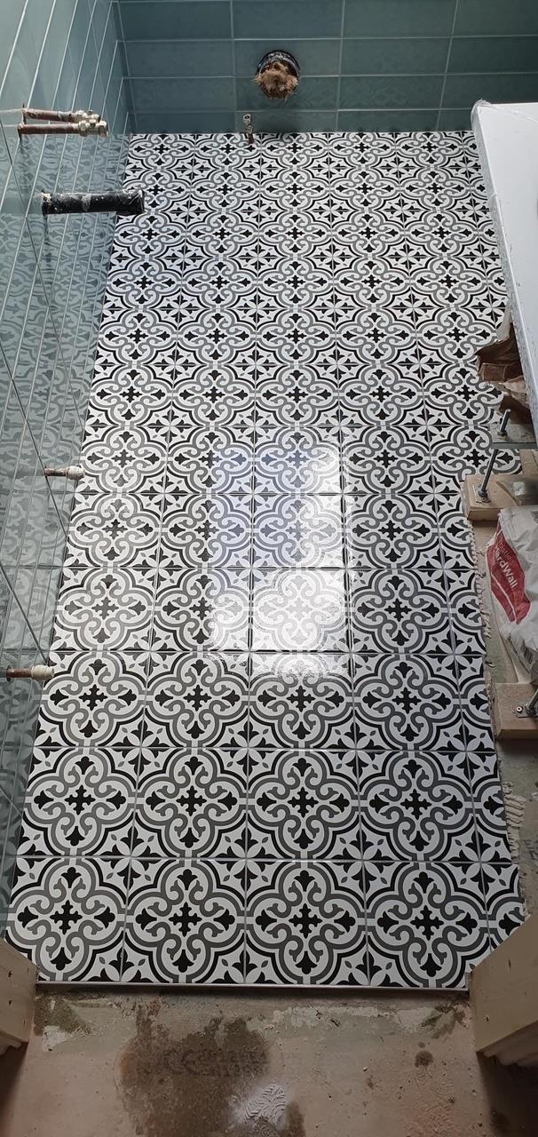 Patterned floor tiles laid in a bathroom by Kew Construction, Liverpool