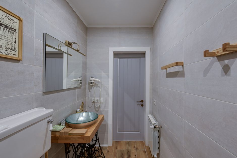 Completed full bathroom renovation Aintree showing walk-in shower and wall panels in a narrow terraced-house bathroom