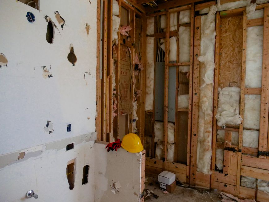 Tile backer board fitted to a bathroom stud wall ready for tiling, showing taped joints and correct substrate preparation