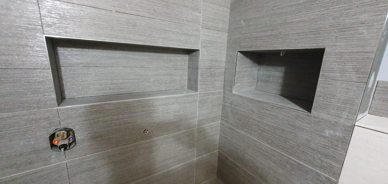 Tiled recessed shower niche by Kew Construction, Liverpool