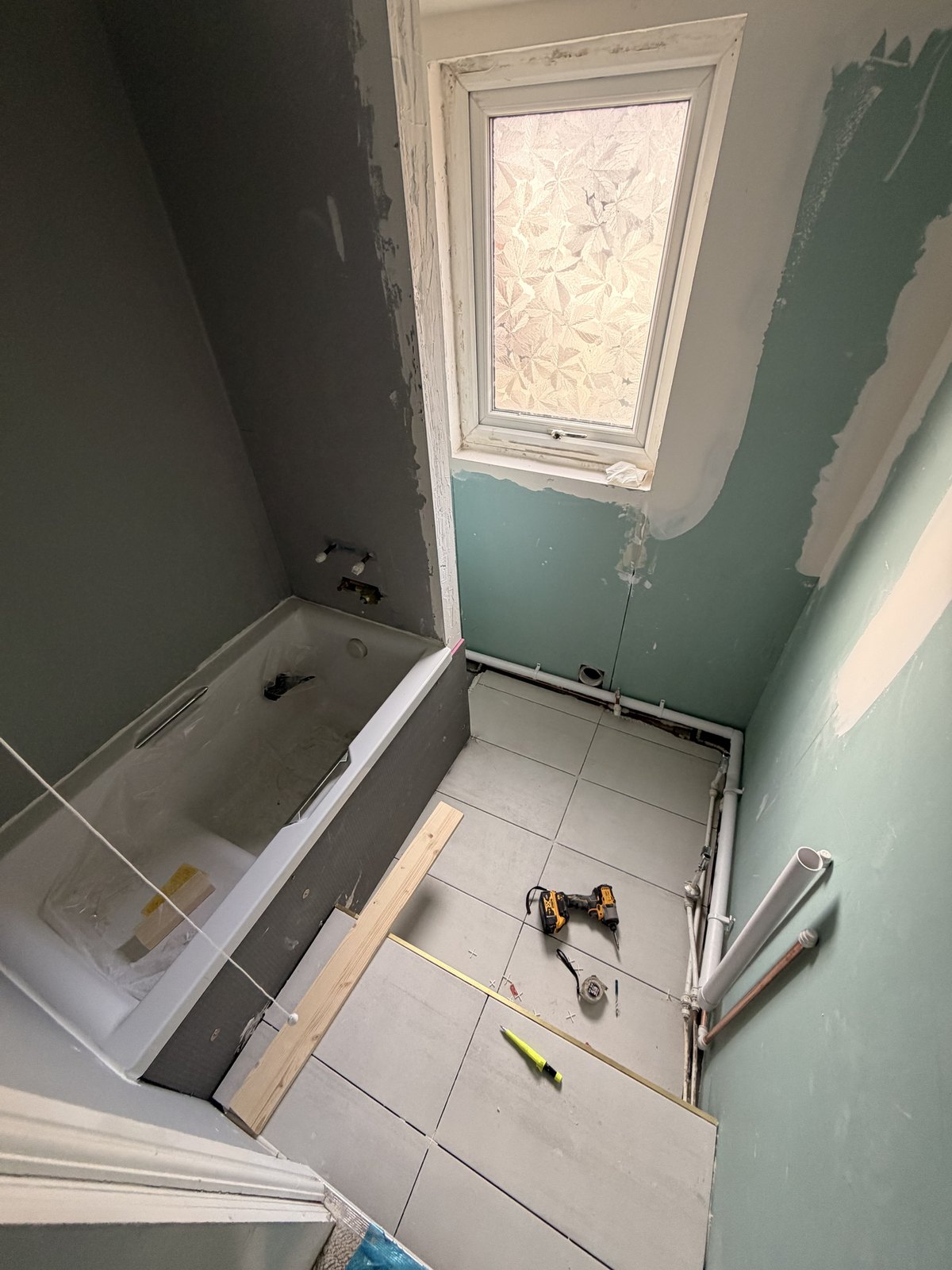 Bathroom refurbishment Liverpool job in progress with new bath, moisture-resistant boards and large porcelain floor tiles