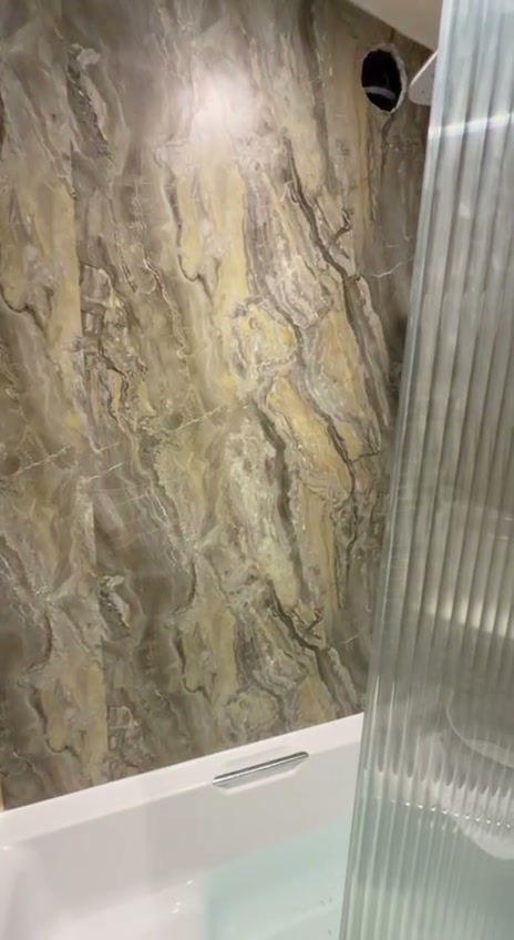 Marble-effect bathroom walls with brushed gold trim and fluted glass, Liverpool