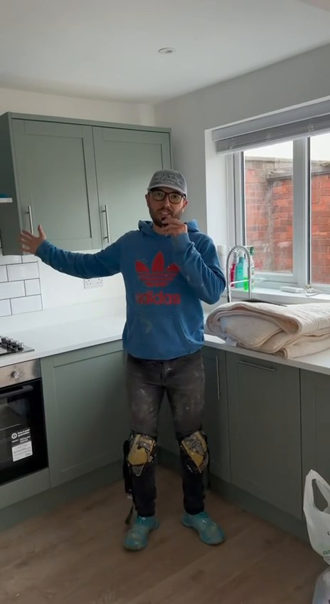Finished kitchen with sage green Shaker units and white metro tiles after a refurbishment in Liverpool